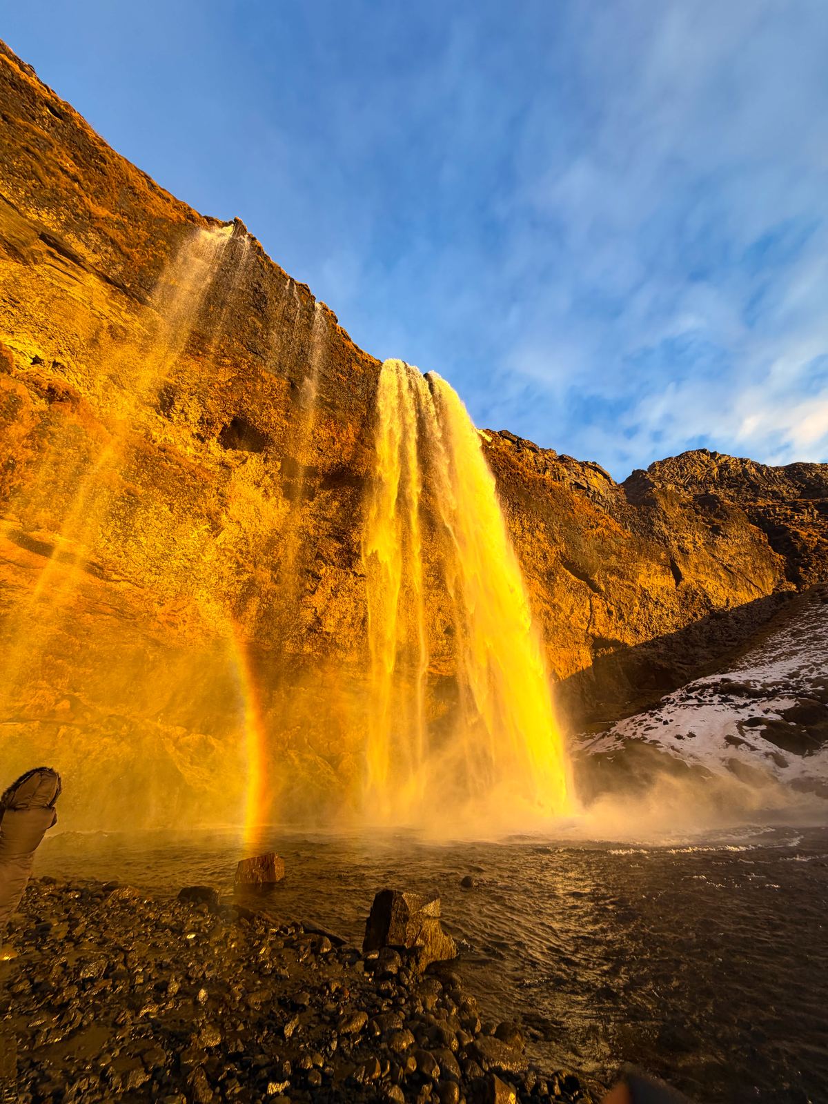 Seljalandsfoss with rainbow at golden hour